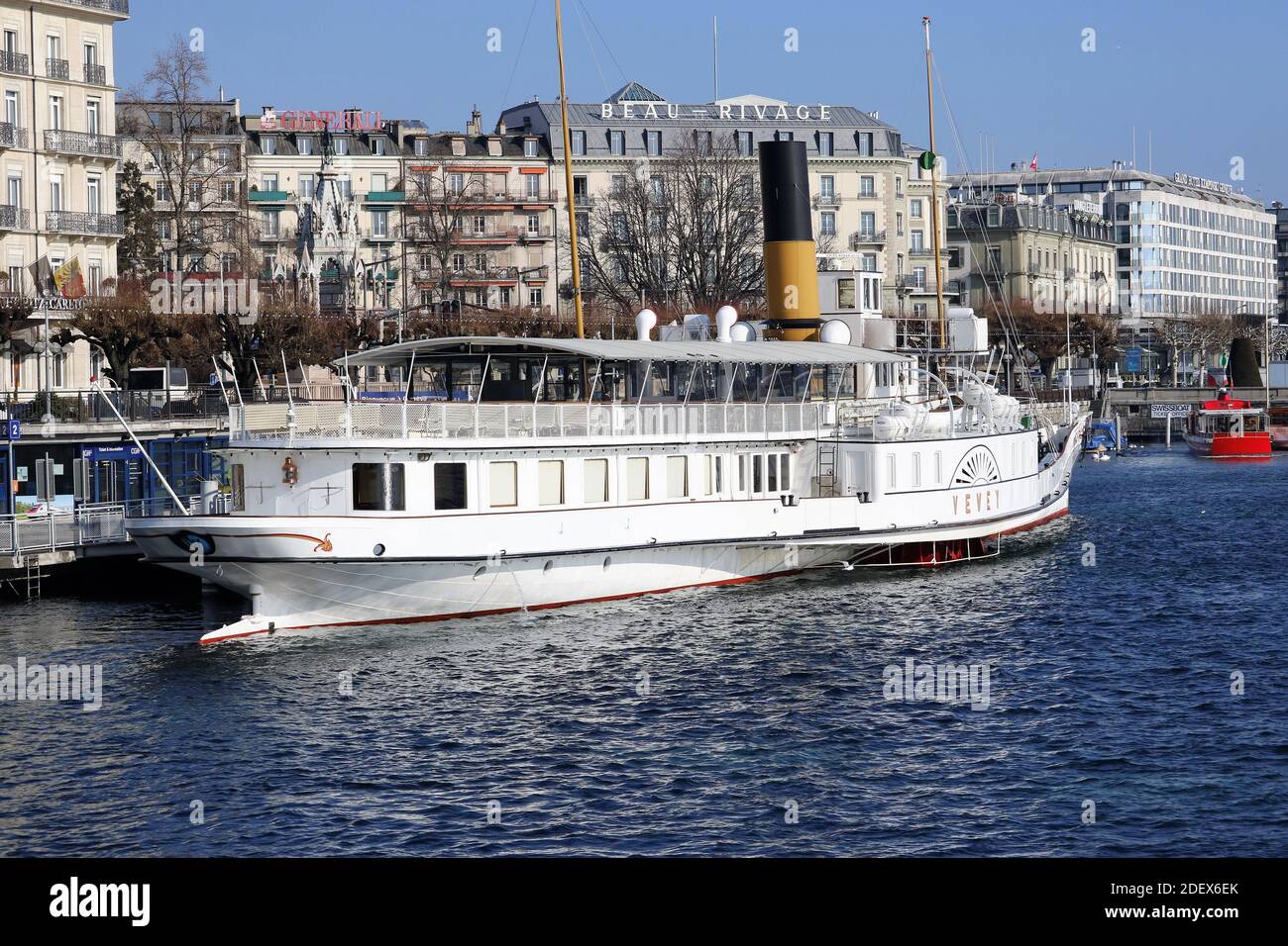 GENEVA, SWITZERLAND - Feb 20, 2018: City trip in Geneva during winter. Picture shows a big boat on the lake and buildings in the background. Stock Photo