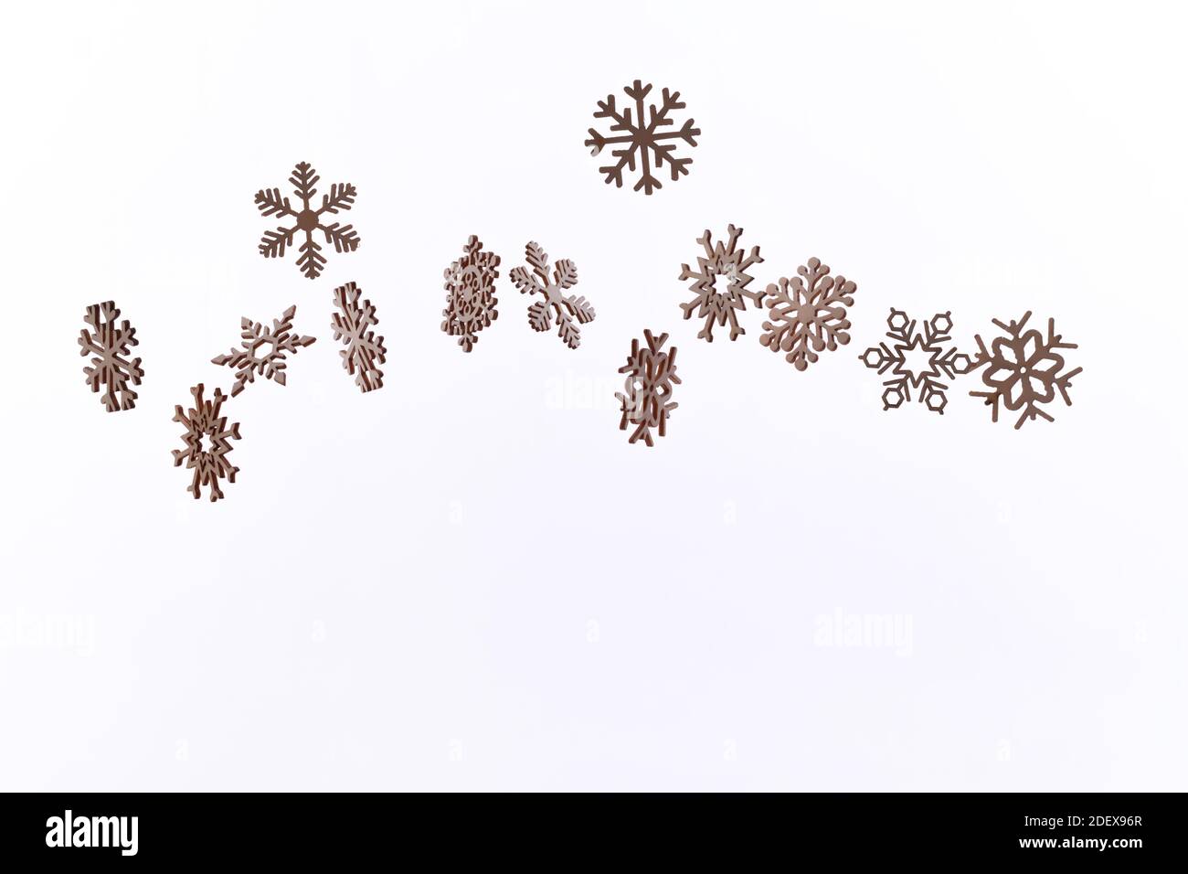 Snowflake pattern with falling snowflakes on a white background with copy space Stock Photo