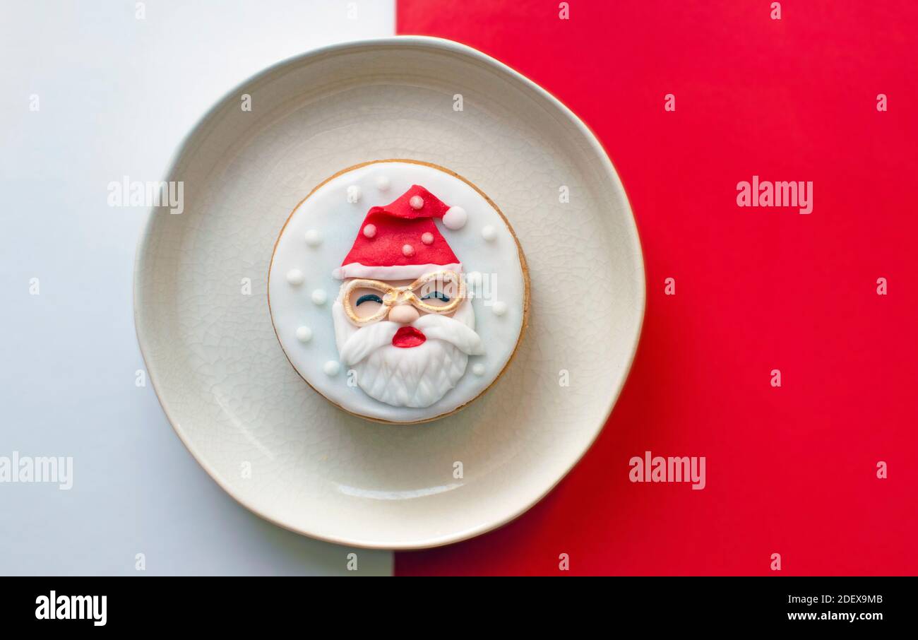 Santa Claus Christmas cookie on red and white background Stock Photo