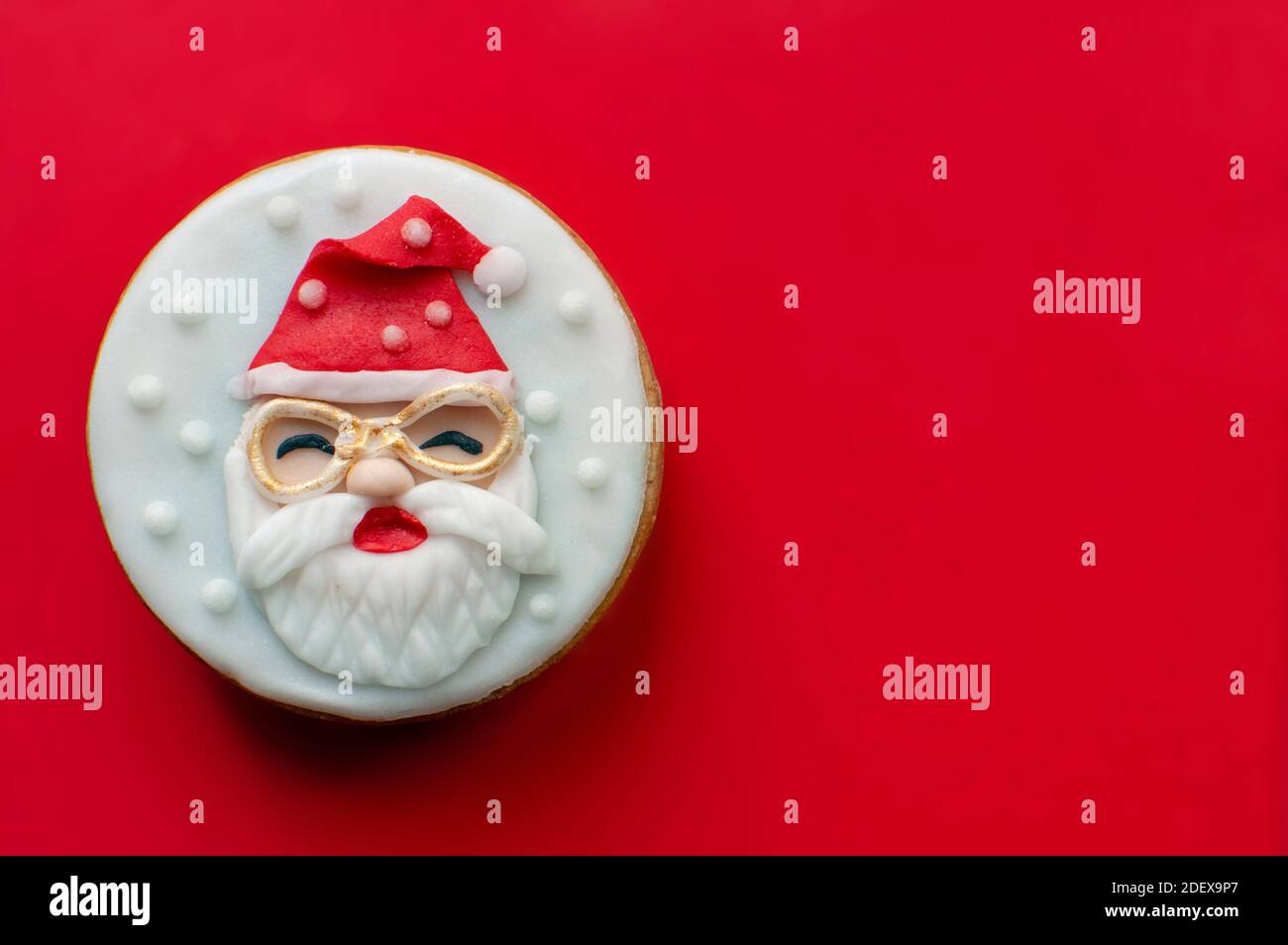 Santa Claus Christmas cookie on red background Stock Photo