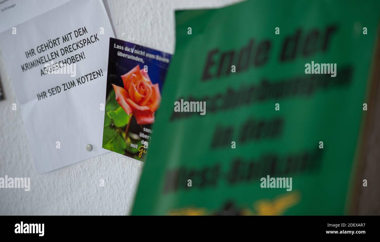 Stuttgart, Germany. 30th Nov, 2020. A hate letter on which 'You should be deported with the criminal scumbag! You make me want to puke,' hangs in the rooms of a refugee organization next to a card on which the Bible quote 'Do not be overcome by evil, but overcome evil with good. Romans 12:21' is written. In the foreground is a poster which reads 'End of deportations to the Western Balkans'. Credit: Sebastian Gollnow/dpa/Alamy Live News Stock Photo