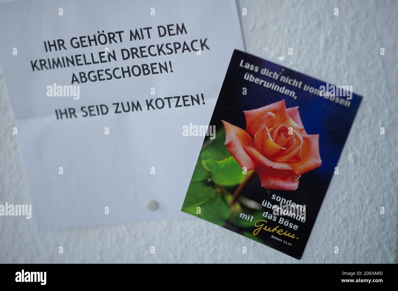 Stuttgart, Germany. 30th Nov, 2020. A hate letter on which 'You should be deported with the criminal scumbag! You make me want to puke,' hangs in the rooms of a refugee organization next to a card on which the Bible quote 'Do not be overcome by evil, but overcome evil with good. Romans 12:21' is written. Credit: Sebastian Gollnow/dpa/Alamy Live News Stock Photo