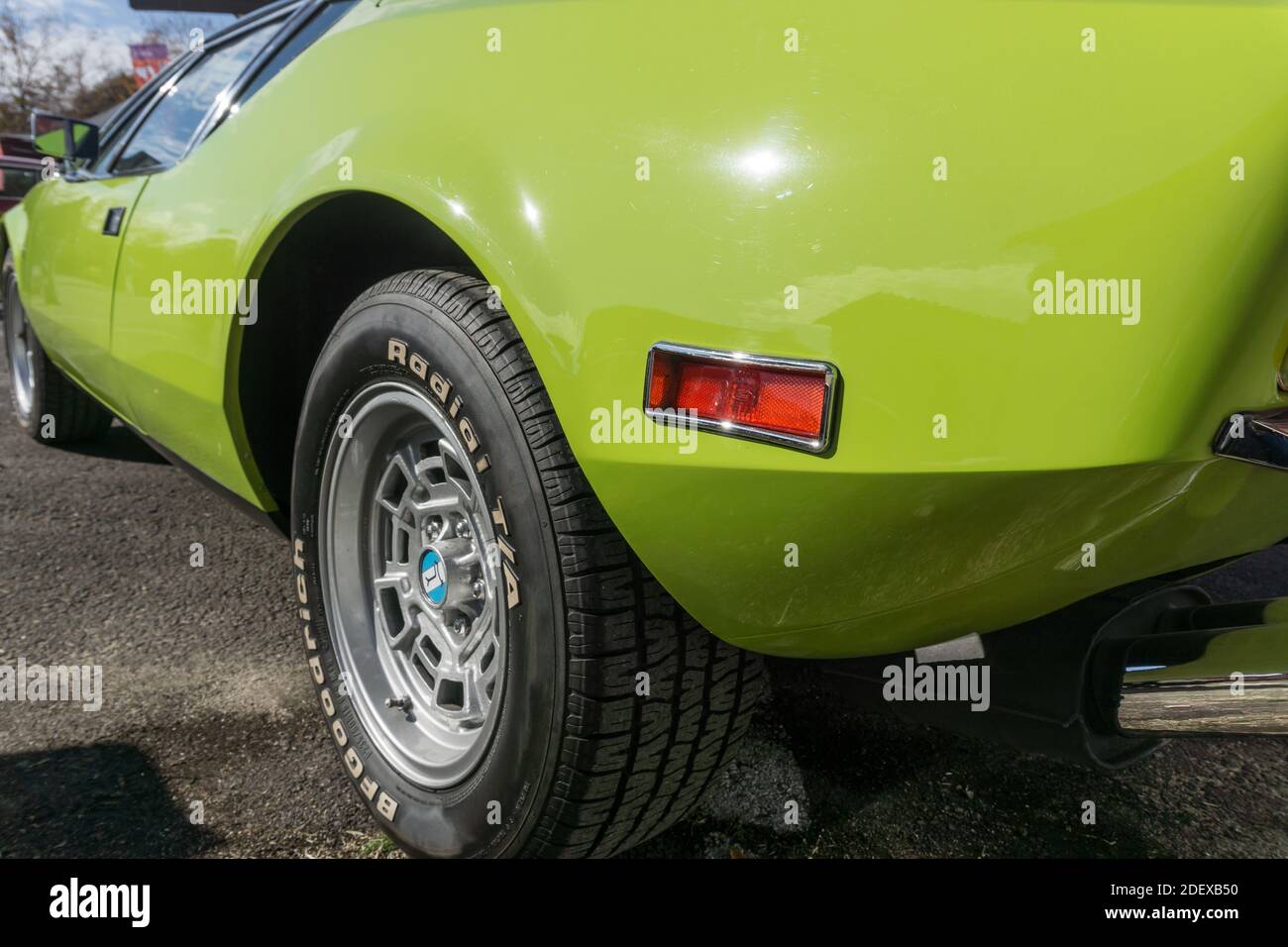 Close up of the Campagnolo rear rim and BF Goodrich tyre on a lime green De Tomaso Pantera outside in sunshine Stock Photo