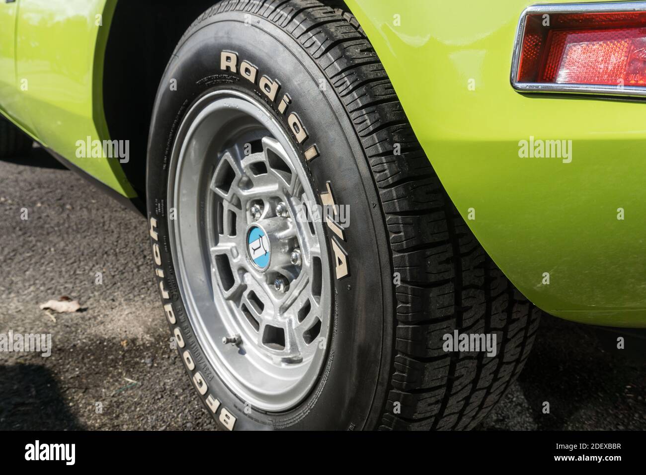 Close up of the Campagnolo rear rim and BF Goodrich tyre on a lime green De Tomaso Pantera outside in sunshine Stock Photo