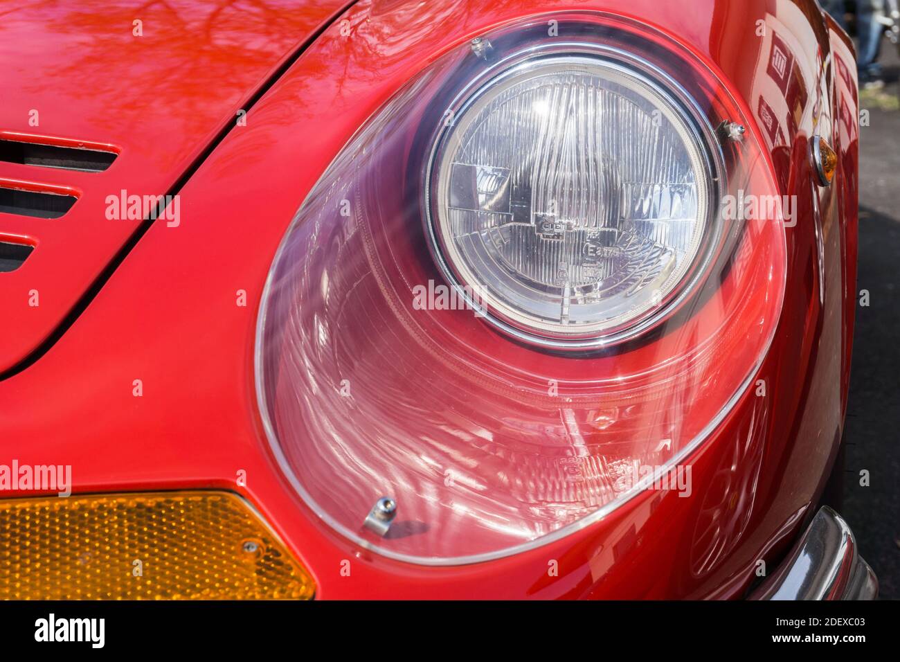 Close up detail of the headlight and bonnet on a red 1970s Ferrari Dino 246 GT sports car Stock Photo