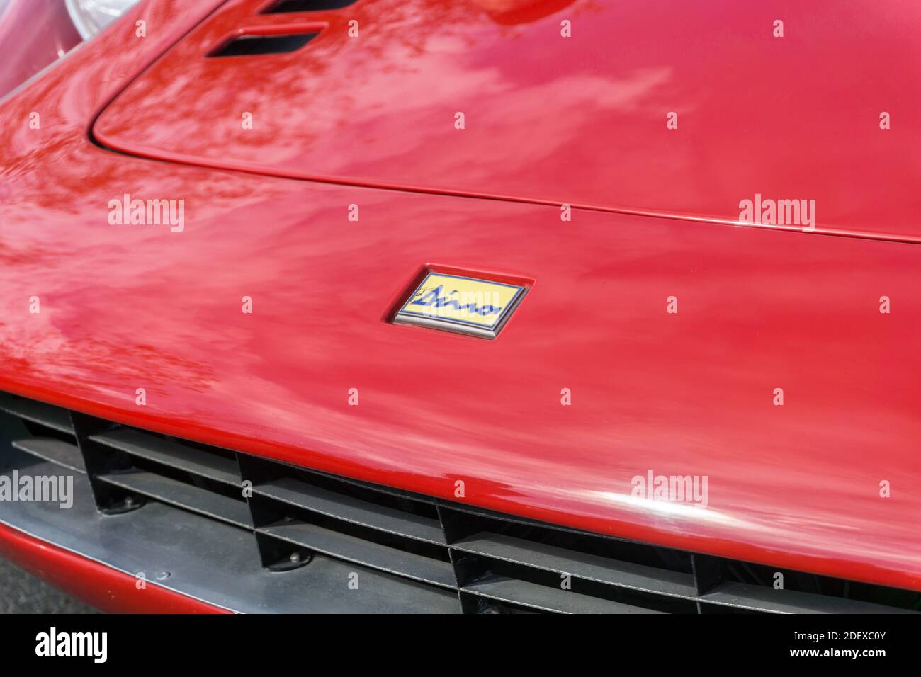 Close up of the logo emblem badge and bonnet of a red 1970s Ferrari Dino 246 GT small sports car Stock Photo