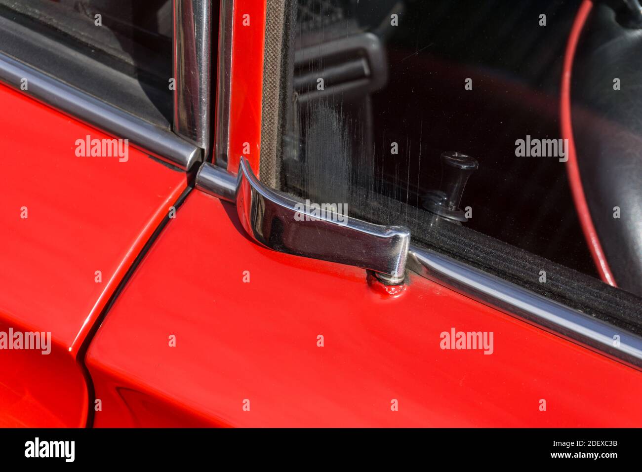Close up detail of the chrome door latch handle on a red 1970s Ferrari Dino 246 GT sports car Stock Photo
