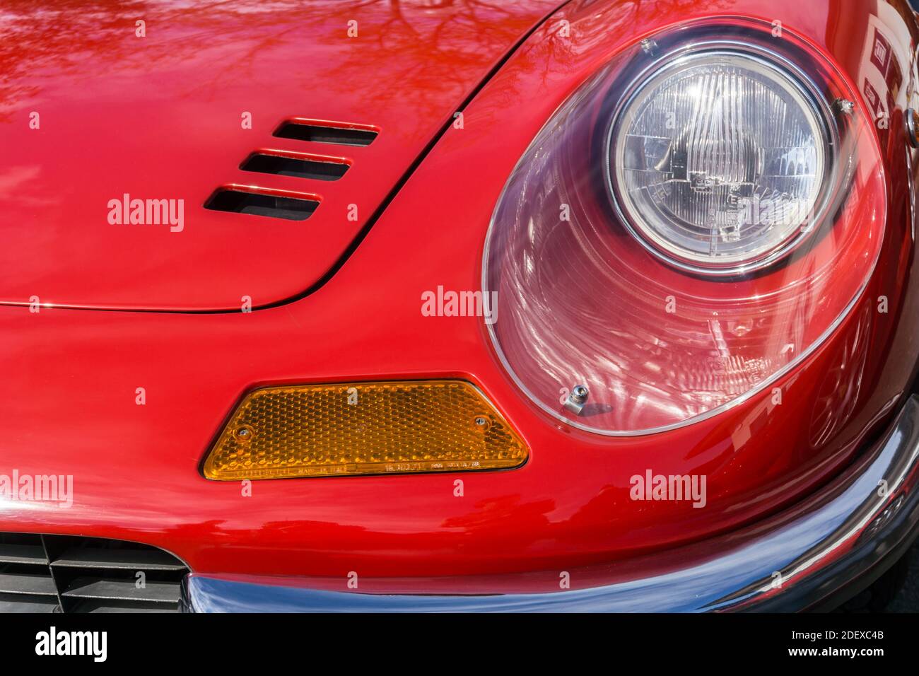 Close up detail of the headlight and bonnet on a red 1970s Ferrari Dino 246 GT sports car Stock Photo