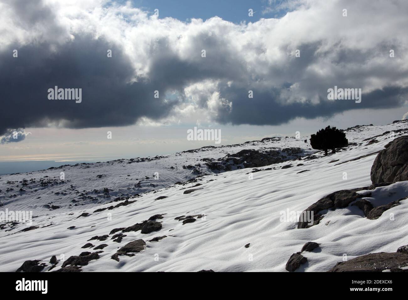 Majorcan mountain, named Massanella, completely snowy, with cloudy blue skies, in 'Serra de Tramuntana'. Stock Photo
