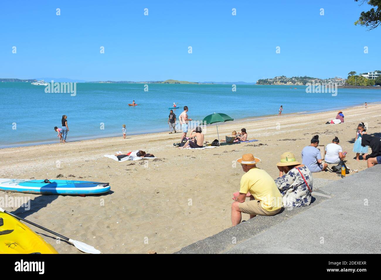 AUCKLAND, NEW ZEALAND - Nov 28, 2020: View of people at Mission Bay beach on weekend day Stock Photo