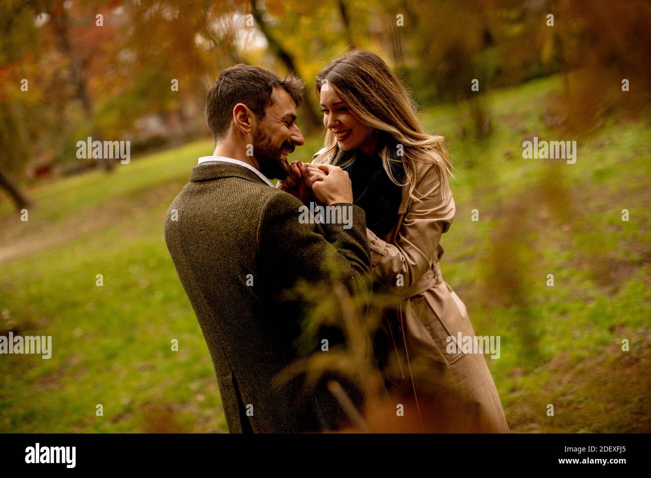Handsome young couple in the autumn park Stock Photo - Alamy