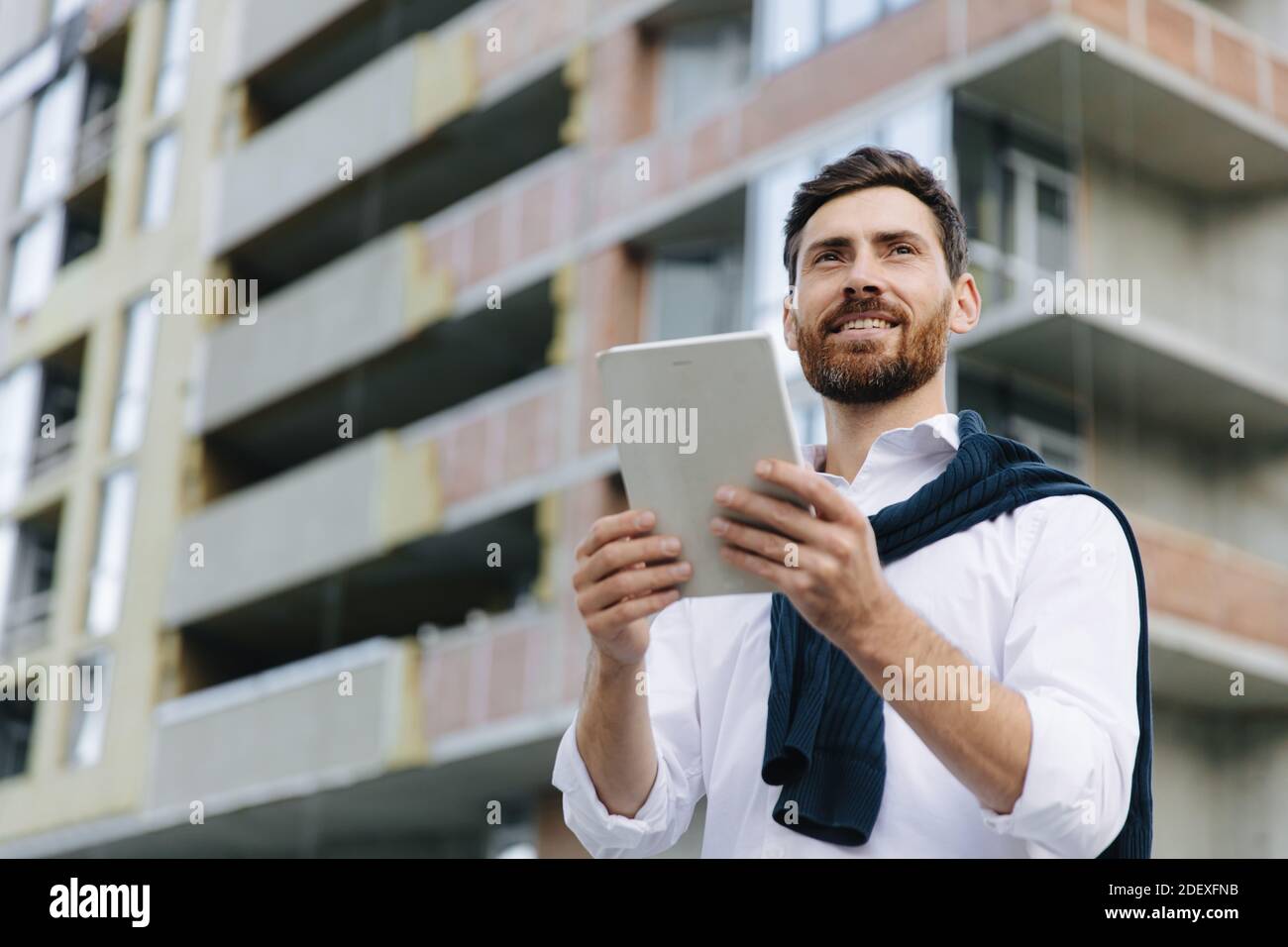 Architect working with tablet on construction project Stock Photo