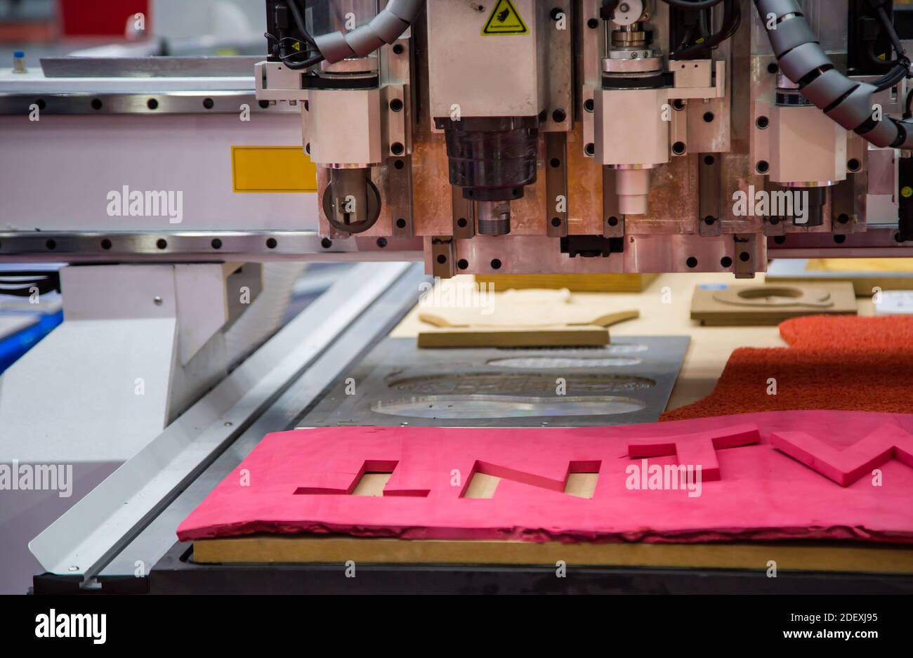 CNC laser cutting machine cutting car carpet mat and engine gasket. Industrial manufacturing