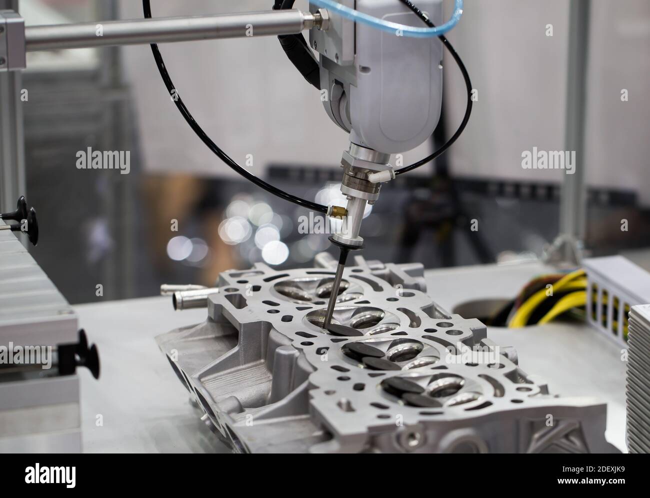 Industrial robot arm demonstrate assembly engine part. Automotive ...