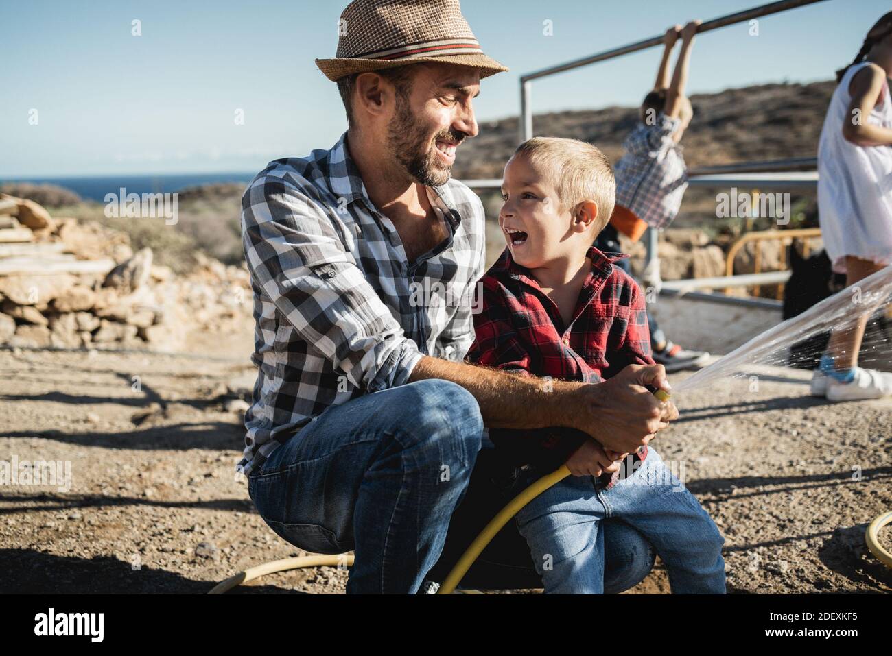 Happy father and son having fun together at ranch farm - Focus on kid face Stock Photo