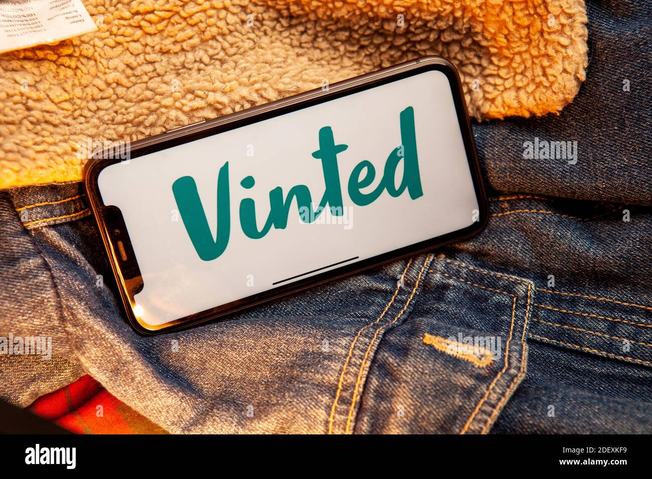 Vinted Iphone screen with vinted logo on screen with hand on vintage wooden  background. Vinted is a Lithuanian online marketplace. #Vinted Stock Photo  - Alamy