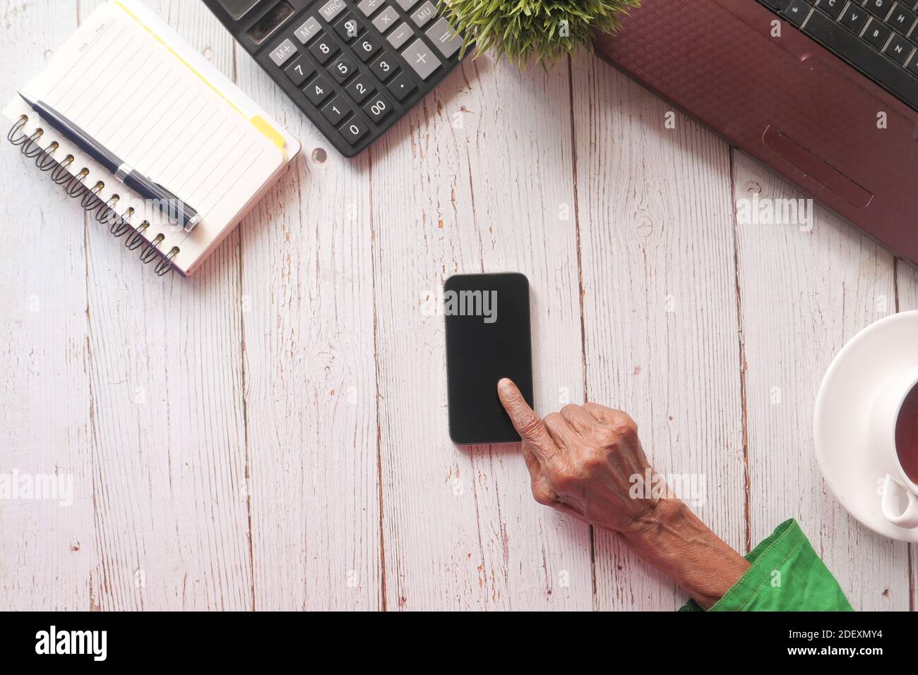 senior women hand using smart phone on table  Stock Photo