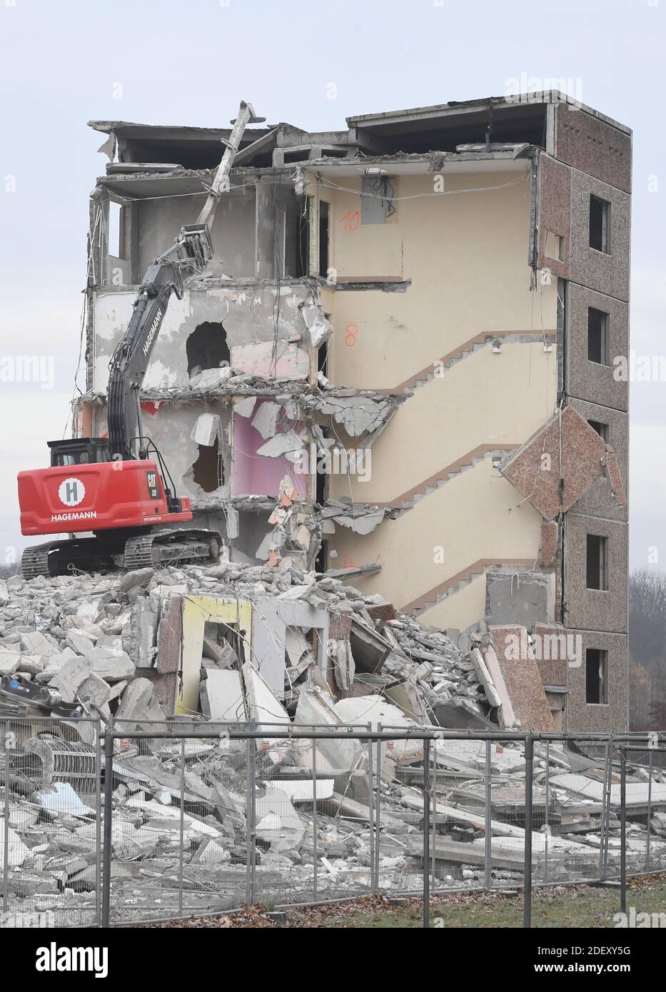 Tutow, Germany. 02nd Dec, 2020. An excavator demolishes a prefabricated concrete slab building in a residential area, each with 44 residential units from GDR times. Since 1990, over 300 apartments have been rebuilt in the community. Credit: Stefan Sauer/dpa-Zentralbild/dpa/Alamy Live News Stock Photo