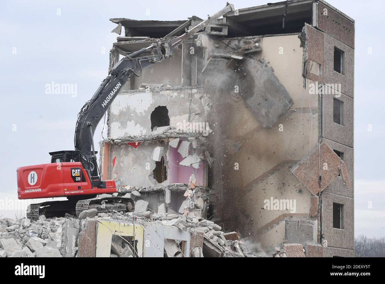 Tutow, Germany. 02nd Dec, 2020. An excavator demolishes a prefabricated concrete slab building in a residential area, each with 44 residential units from GDR times. Since 1990, over 300 apartments have been rebuilt in the community. Credit: Stefan Sauer/dpa-Zentralbild/dpa/Alamy Live News Stock Photo