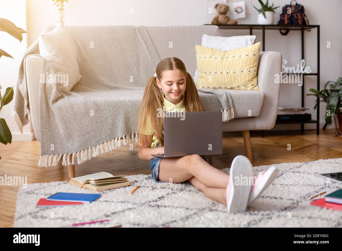 Girl sitting on floor and using her persinal laptop computer Stock ...