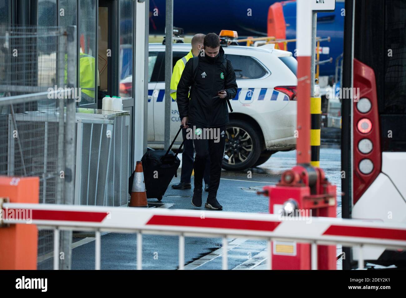 Glasgow, Scotland, UK. 2 December 2020.  Pictured: Players from Celtic Football Club seen at Glasgow Airport getting off their bus and going through security before flying out to Milan in Italy where they will play AC Milan in their group stage game 5 of 6 in Group H tomorrow evening. Glasgow, Scotland, UK. 2 December 2020.  Pictured: Players from Celtic Football Club seen at Glasgow Airport getting off their bus and going through security before flying out to Milan in Italy where they will play AC Milan in their group stage game 5 of 6 in Group H tomorrow evening.  Credit: Colin Fisher/Alamy Stock Photo