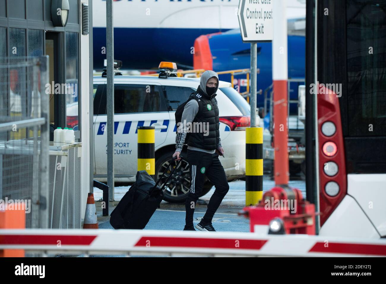 Glasgow, Scotland, UK. 2 December 2020.  Pictured: Players from Celtic Football Club seen at Glasgow Airport getting off their bus and going through security before flying out to Milan in Italy where they will play AC Milan in their group stage game 5 of 6 in Group H tomorrow evening. Glasgow, Scotland, UK. 2 December 2020.  Pictured: Players from Celtic Football Club seen at Glasgow Airport getting off their bus and going through security before flying out to Milan in Italy where they will play AC Milan in their group stage game 5 of 6 in Group H tomorrow evening.  Credit: Colin Fisher/Alamy Stock Photo