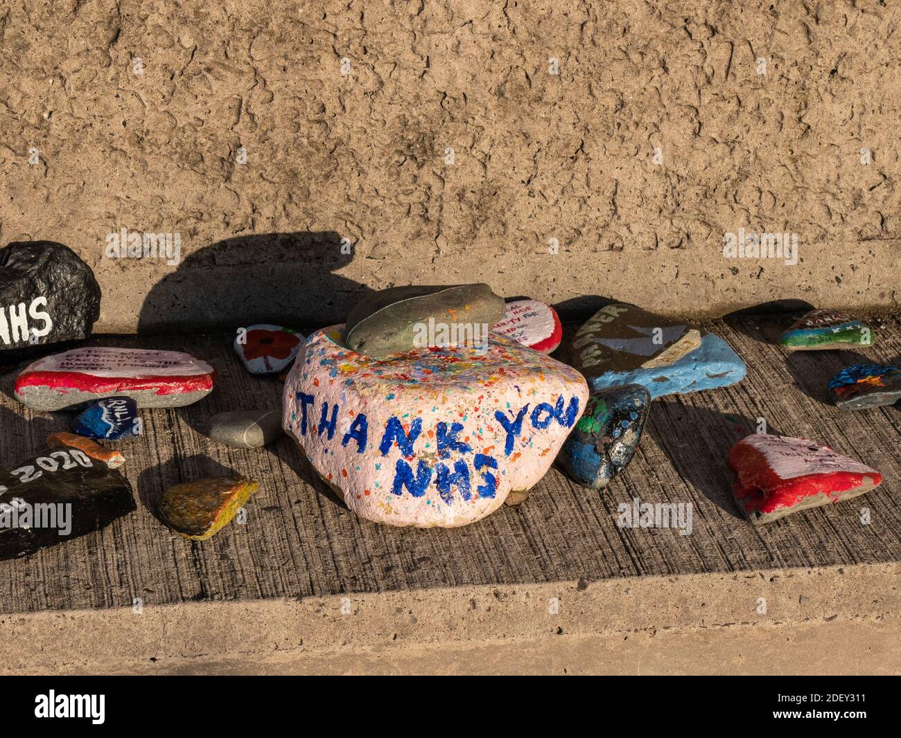 Bangor, Northern Ireland, UK, 2 December 2020: Stones and pebbles on Eisenhower Pier painted with messages of support for NHS staff and keyworkers during the Coronavirus pandemic Stock Photo