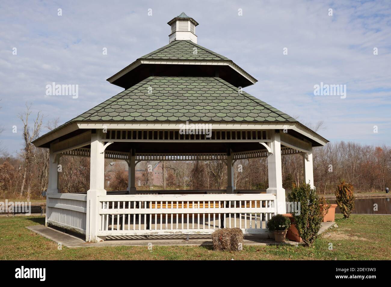 The white gazebo is in the park by the pond Stock Photo - Alamy