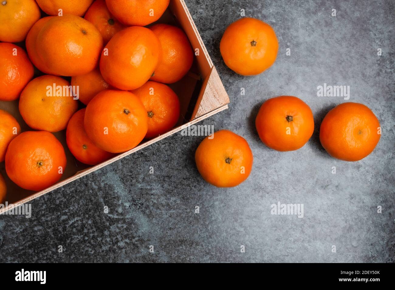 above view of wooden crate filled with clementines on kitchen counter Stock Photo