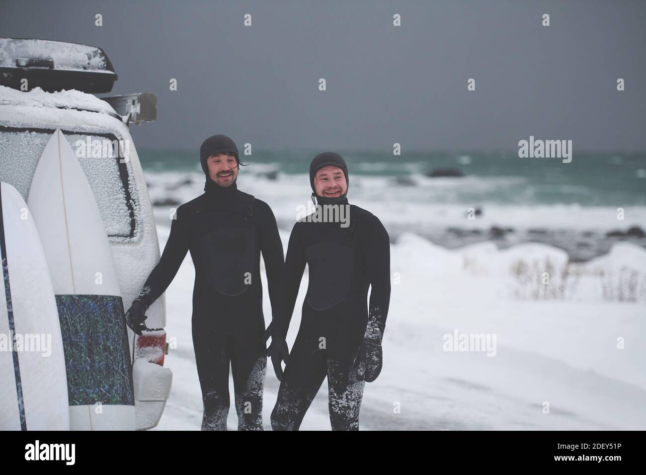 Arctic surfers in wetsuit after surfing by minivan Stock Photo Alamy