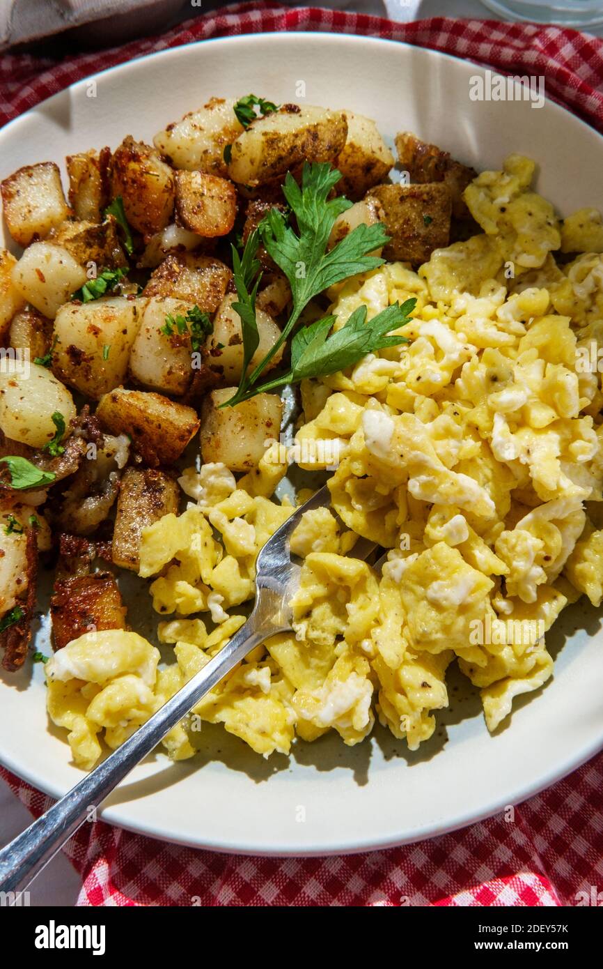 American scrambled eggs with home fries and milk a complete breakfast Stock Photo Alamy