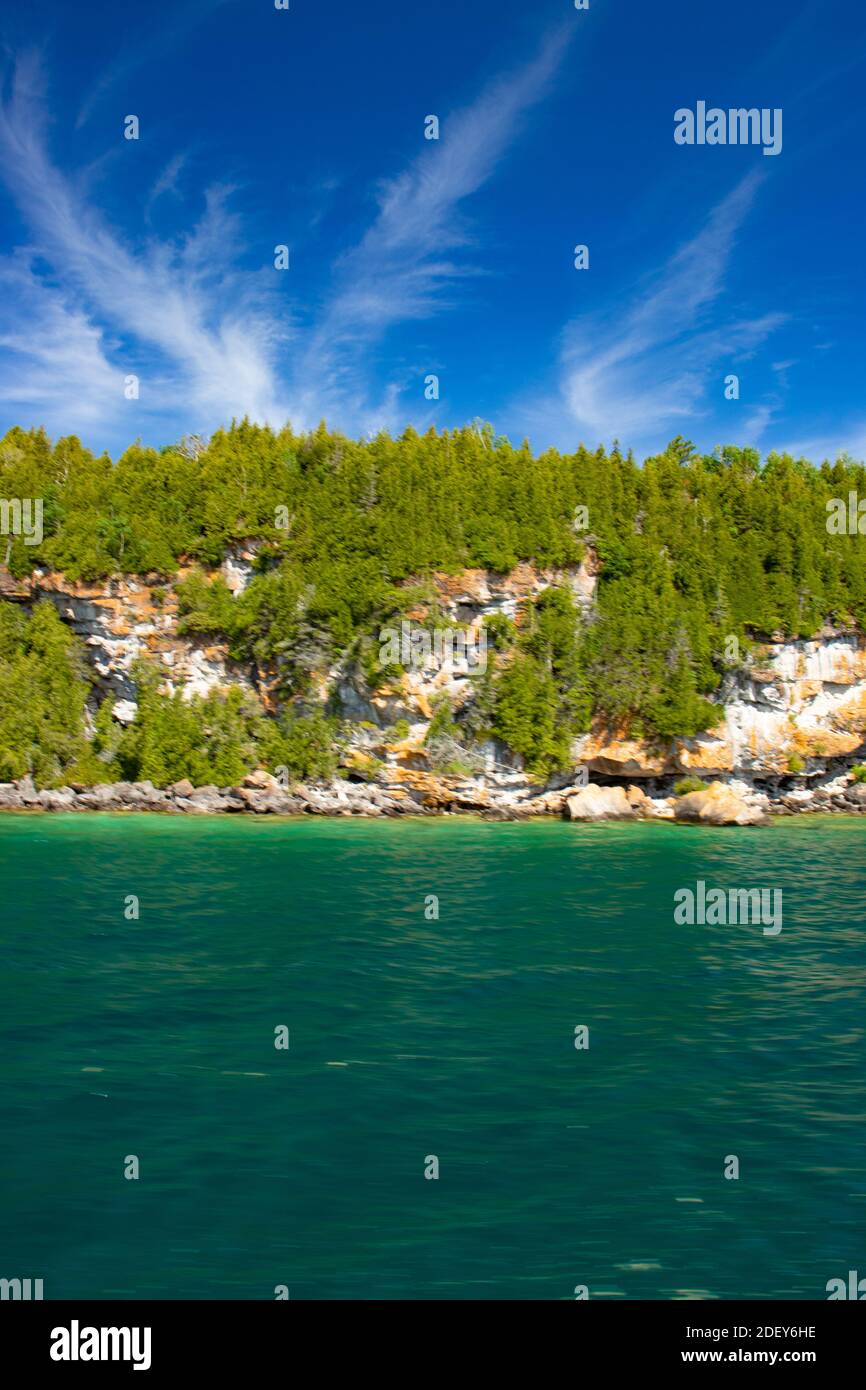 Dramatic sky, cliffs and turquoise water put up a great show on Lake Huron, ON. Spectacular scenery in the summer in Georgian Bay in ON, Canada. There Stock Photo