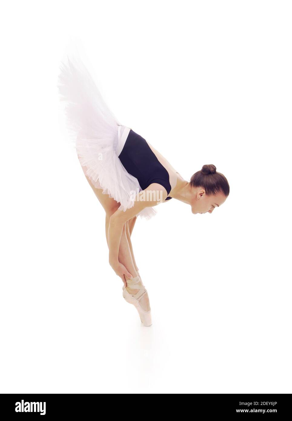 Gorgeous ballerina, in a white tutu dancing ballet. Studio shot on