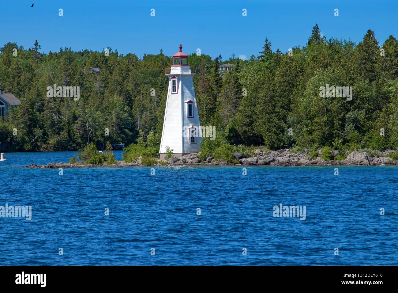 Blue waters of Lake Huron and the big tub lighthouse, ON. Spectacular scenery in the summer in Georgian Bay in ON, Canada. There are over 30,000 islan Stock Photo