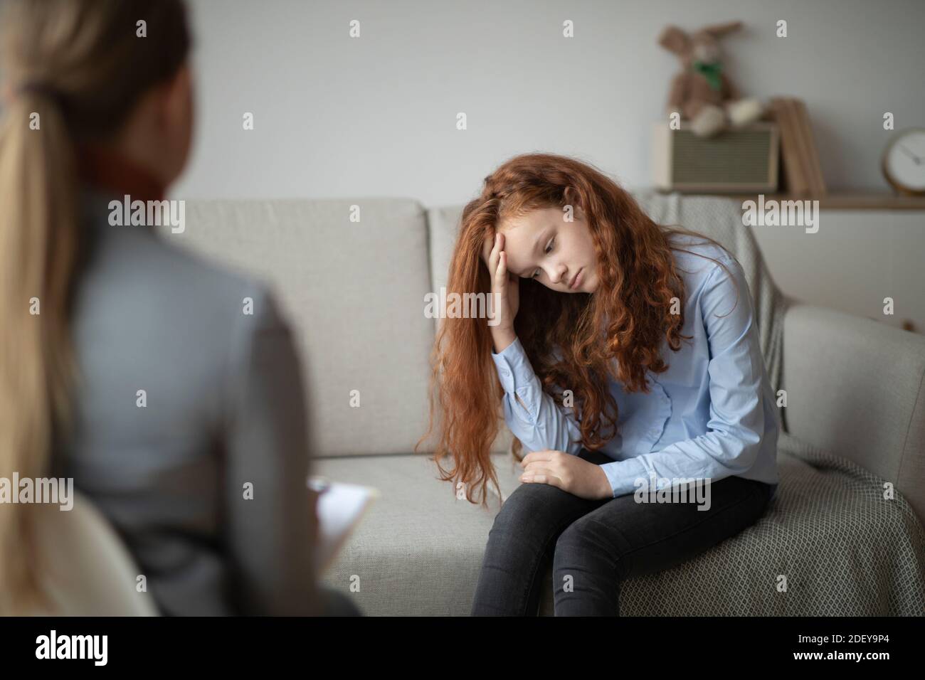 Child Psychologist. Worried sad teen girl having session with doctor Stock Photo