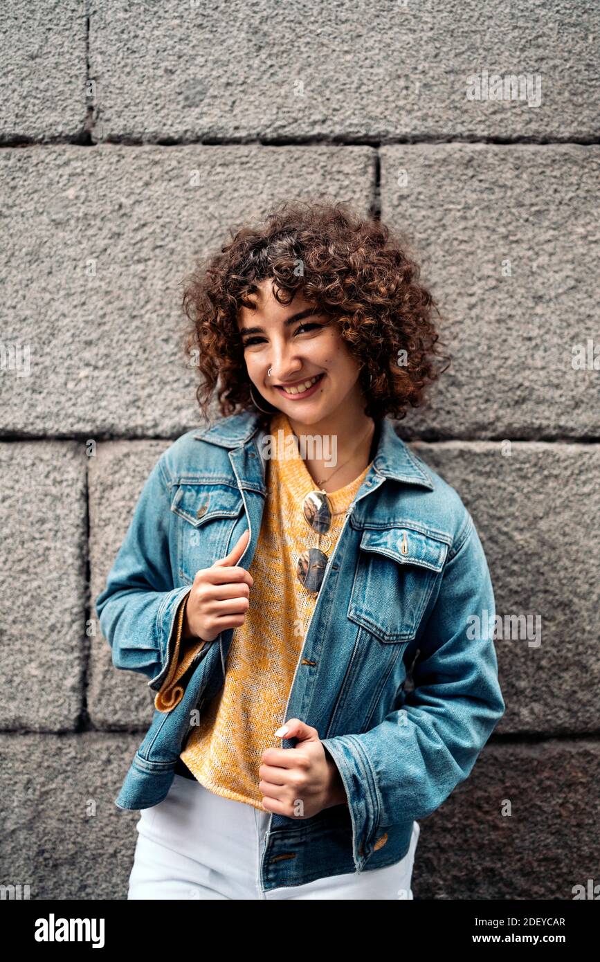 Stock photo of beautiful girl with short curly hair smiling and looking at  camera Stock Photo - Alamy