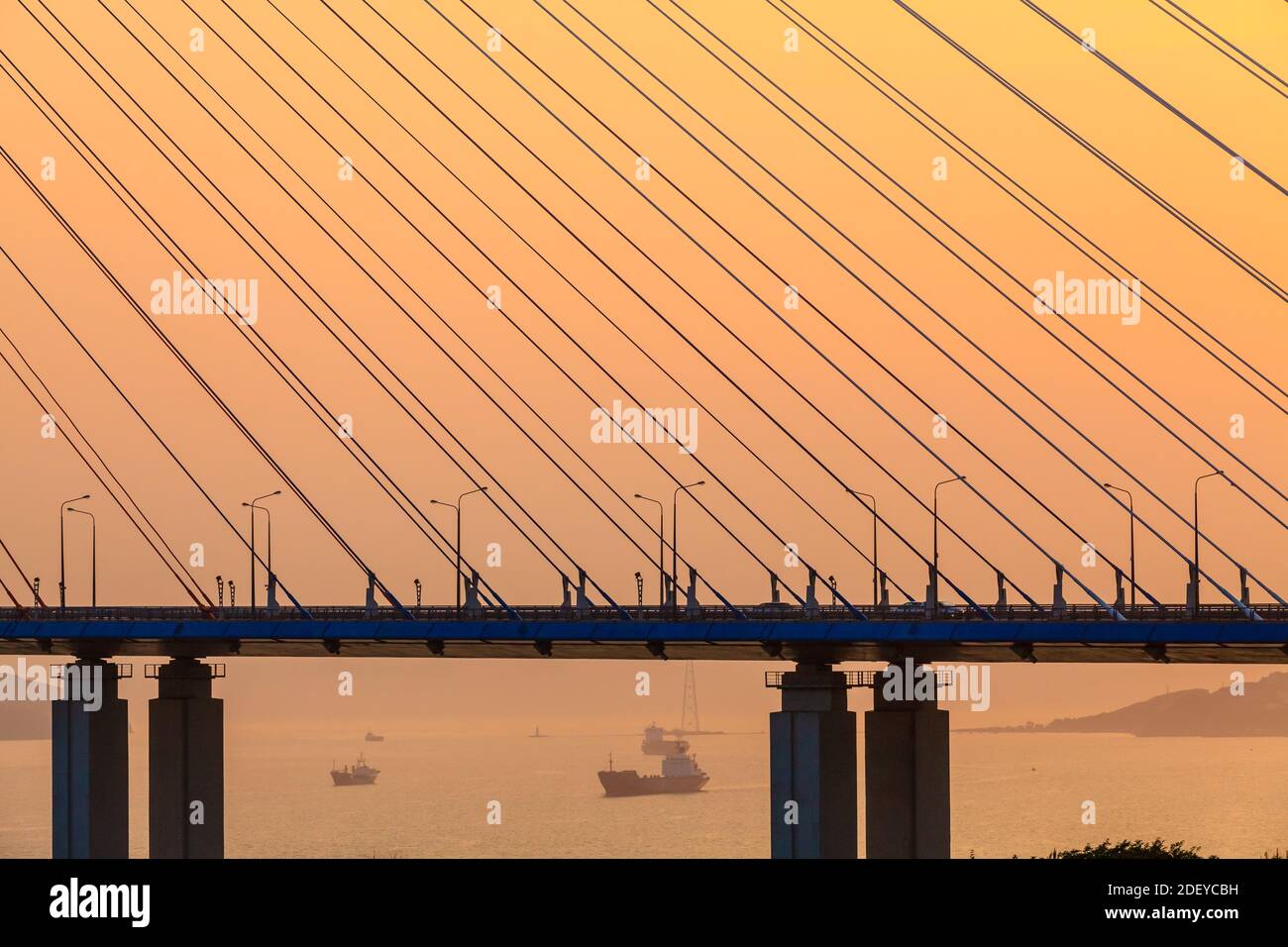 Fragment of the cable-stayed bridge - Russky Bridge to island Russkiy on the sunset. Vladivostok, Russia Stock Photo