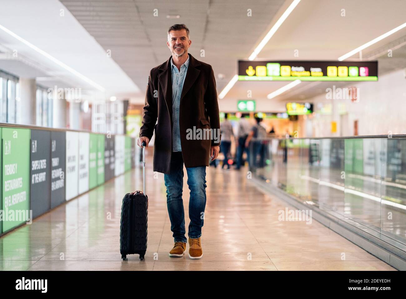 Stock photo of a caucasian business man walking in the airport with a ...