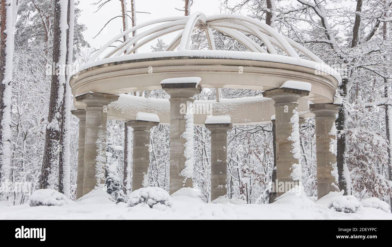 Beautiful colonnade in the snowy park, Bucha Ukraine Winter fresh morning Stock Photo