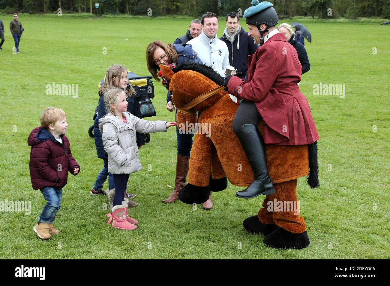 Man in fancy dress costume as horse and rider in period costume riding along side a wicker horse, a unicorn and a fairground at Burns an a that festival, Rozelle Park, Ayr, Ayrshire, Scotland. UK Stock Photo