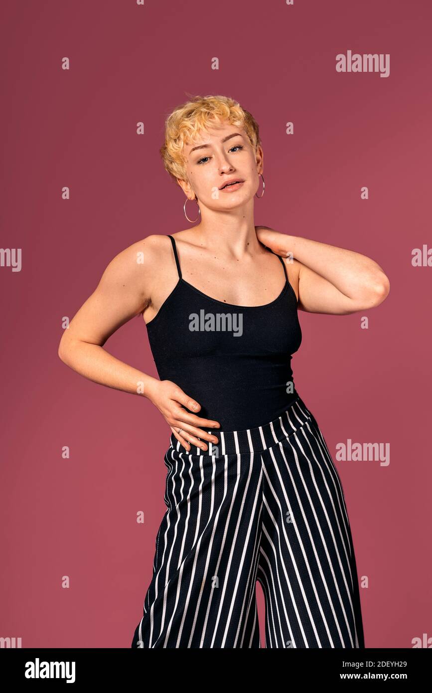 Stock photo of expressive girl wearing black tank top standing and ...