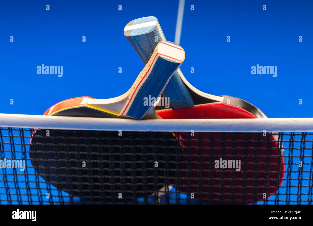 Two Table Tennis Rackets Two table tennis rackets and balls on a blue table with net Stock Photo ...