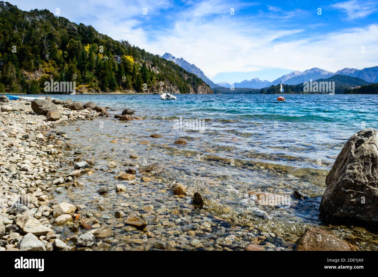 Beautiful lake of bariloche with rocks, pine trees, water, mountains Stock Photo