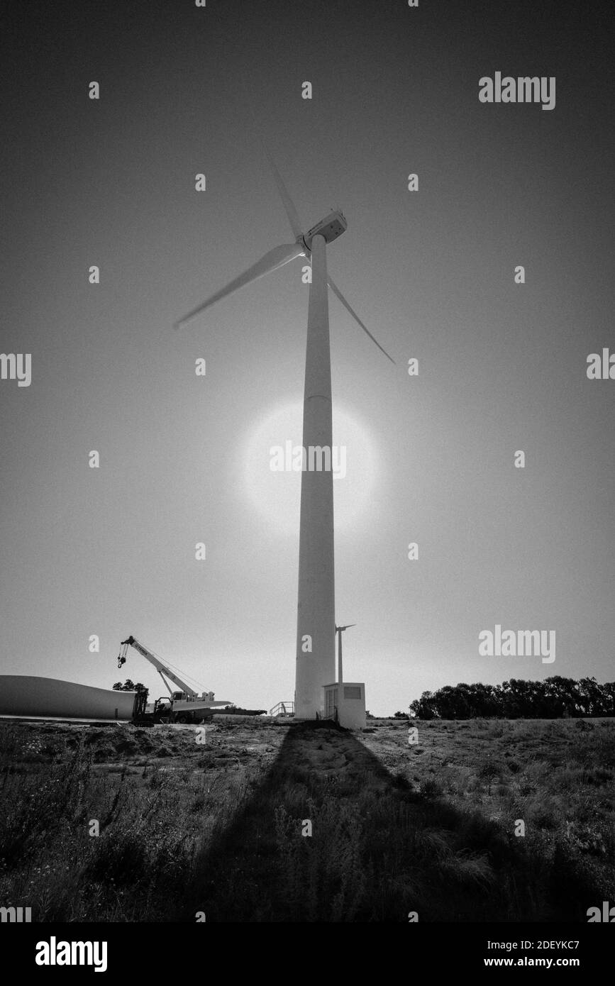 Black and white picture of a windmill at main focus - V-orientation Stock Photo