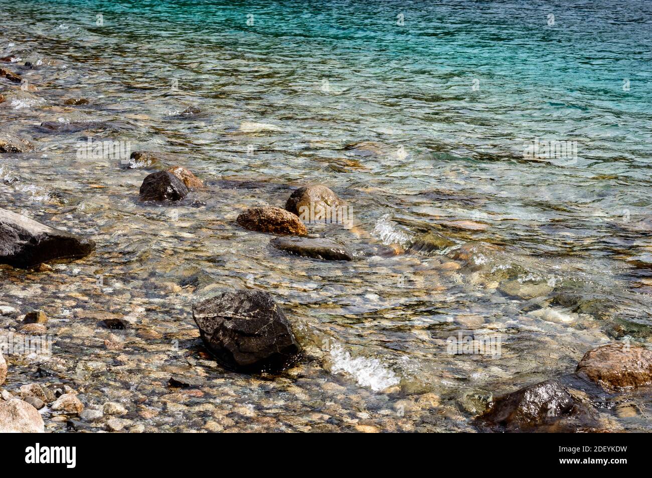 Beautiful lake of bariloche with rocks, pine trees, water, mountains Stock Photo