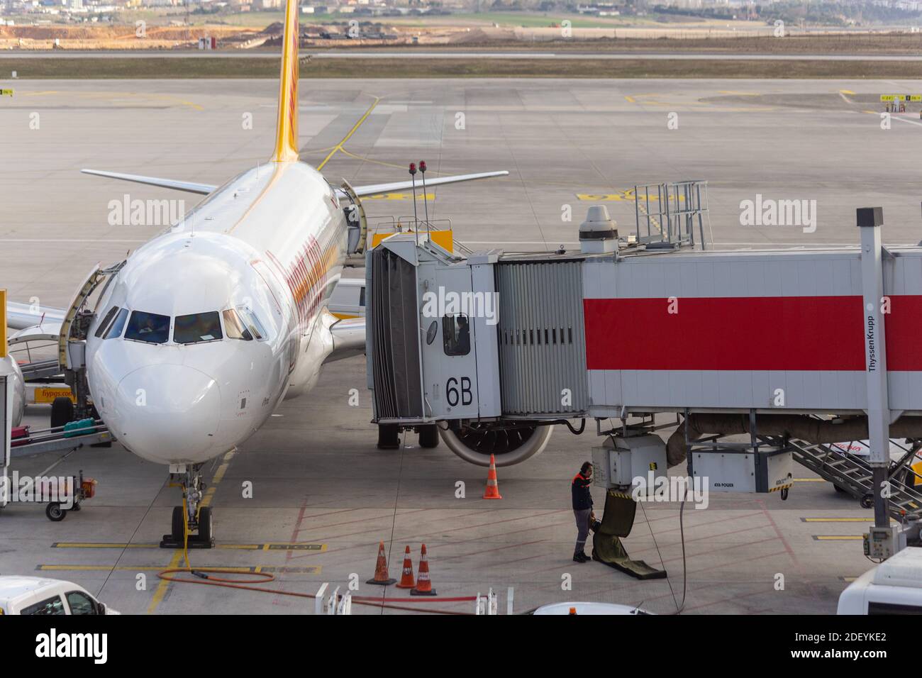 Jet bridge controlled by two operators approach to an Airbus plane on ...