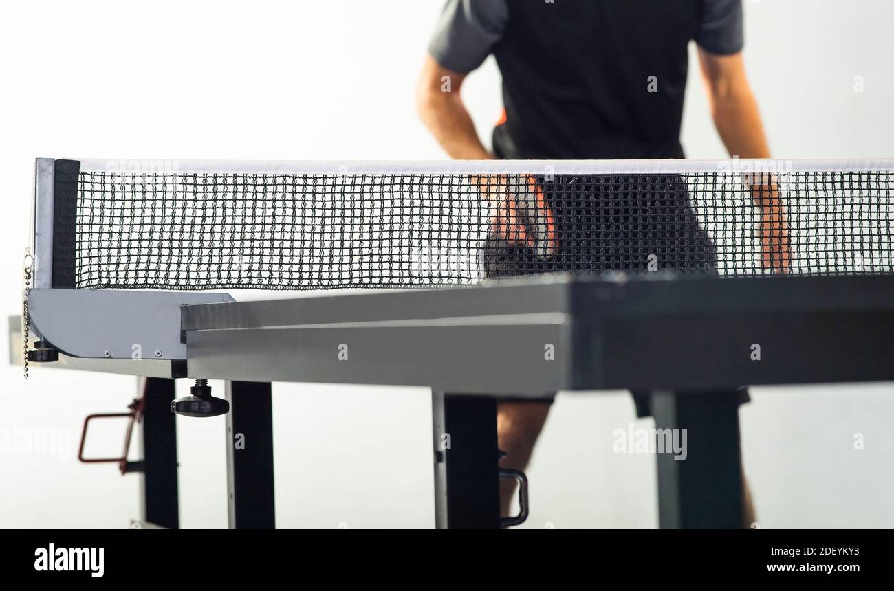 Ping pong in action, focus on net and white ball Stock Photo Alamy
