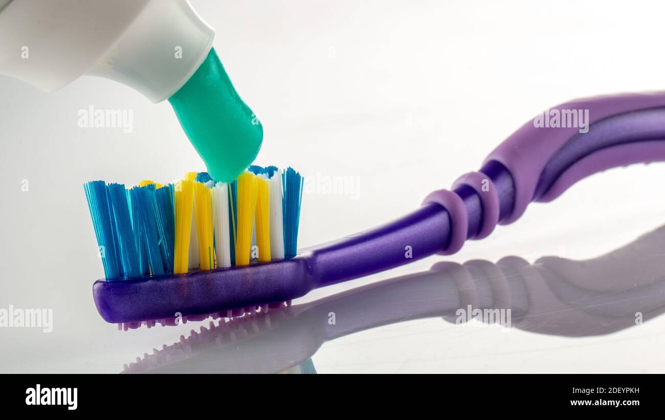 Toothpaste on a toothbrush on a white background Stock Photo - Alamy