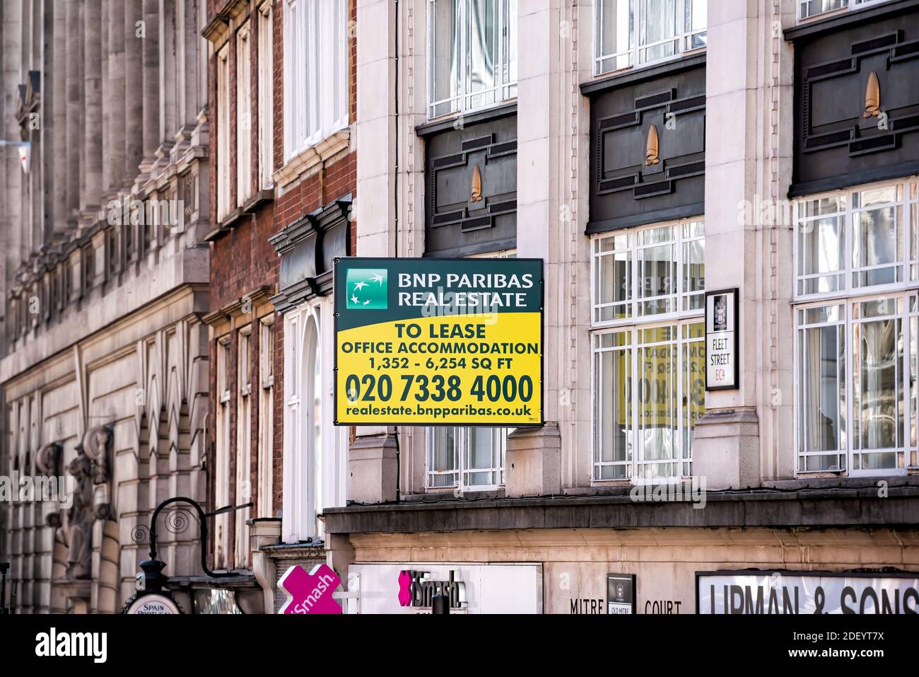 London, UK - June 22, 2018: Fleet street road in center of downtown city with sign for BNP Paribas Real Estate office lease and phone number Stock Photo