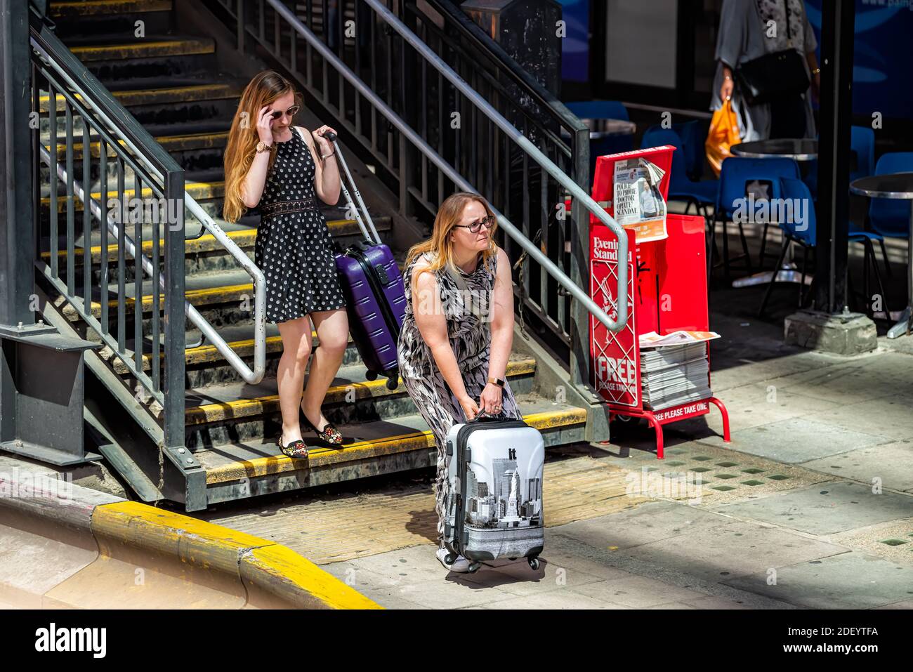 London, UK - June 22, 2018: People candid outside with luggage baggage ...